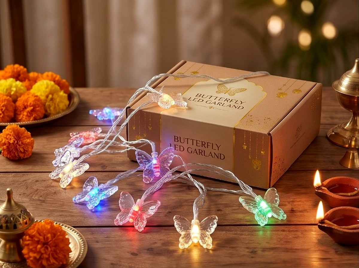 Actual product photo of a 3 metre multicolour butterfly LED garland with transparent wiring and colourful illuminated butterfly lights, shown with its product box