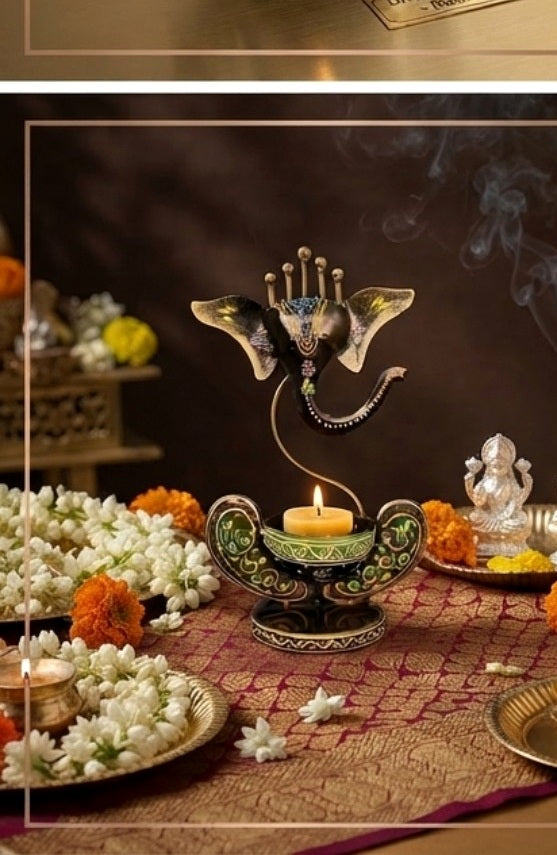 Decorative Ganesha tea-light holder displayed in a traditional pooja setting