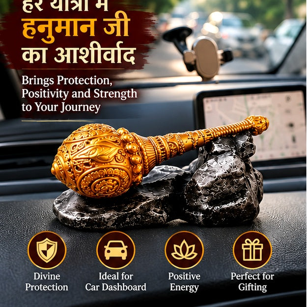 Golden Hanuman gada showpiece displayed on a car dashboard