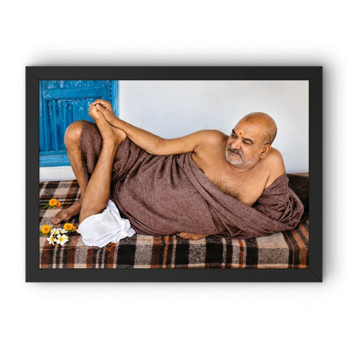 Neem Karoli Baba reclining portrait in a black landscape photo frame on a clean background
