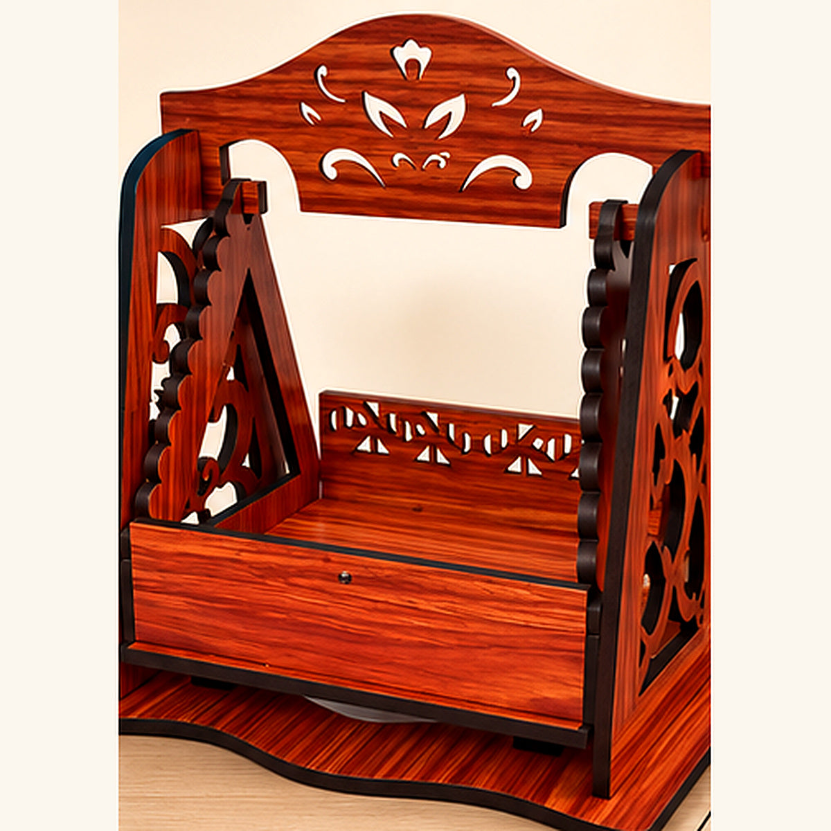 Angled view highlighting decorative side panels and the front tray of the wooden-finish deity jhula
