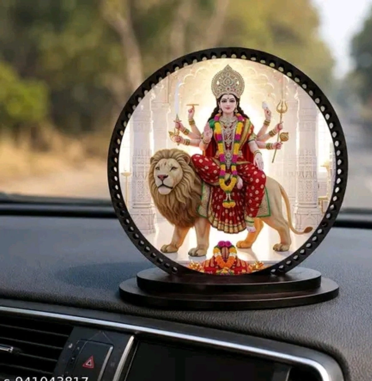Maa Durga dashboard décor positioned inside a car