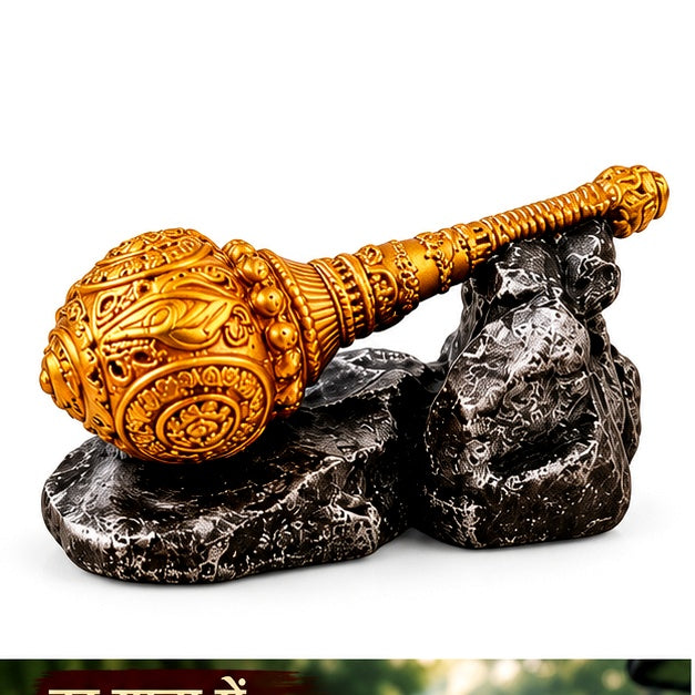 Clean product-only view of ornate golden Hanuman gada showpiece resting on a dark stone-look base