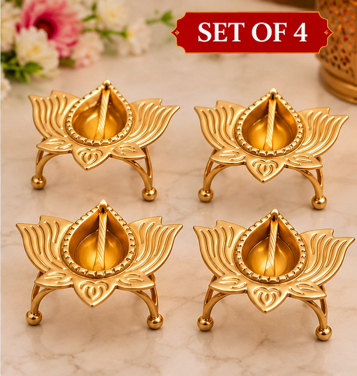 Four golden lotus diya holders — clear product view