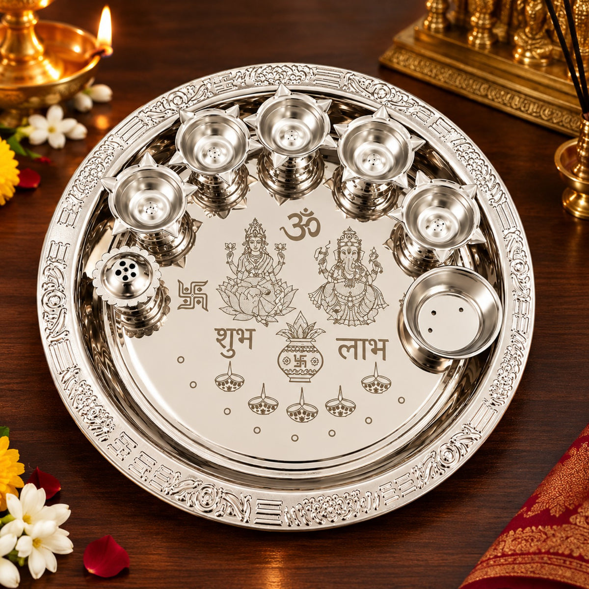 Silver-finish Lakshmi Ganesha pooja thali set arranged on a wooden devotional table with flowers and lit brass diyas