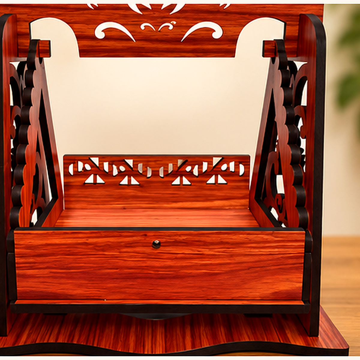 Close-up view of the decorative carving and front tray of the deity jhula
